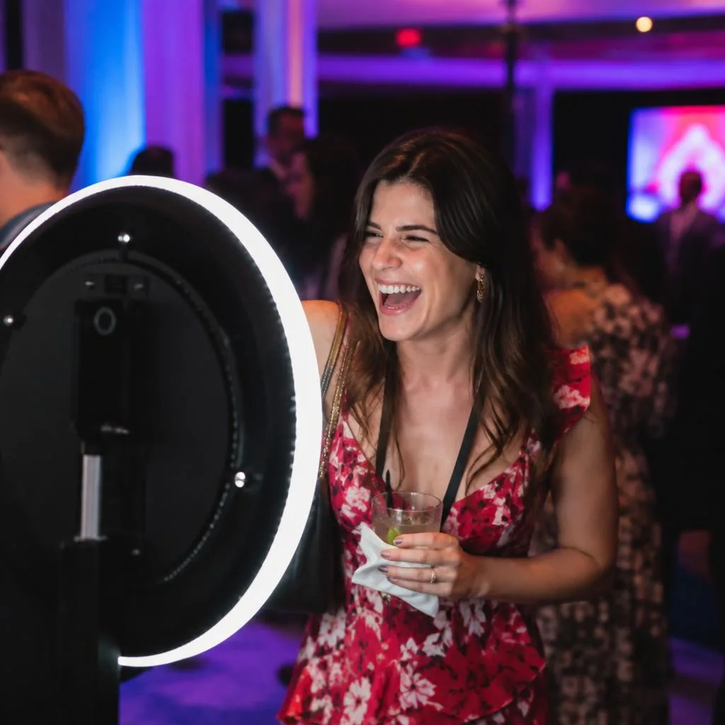 A guest laughing in front of the ring light